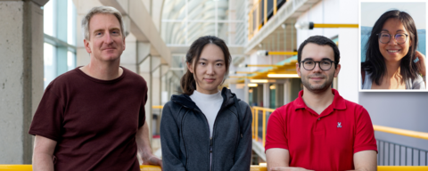 Three individuals stand together in an indoor space with a modern design, featuring large windows and yellow railings. A smaller inset image of a person is visible in the corner.