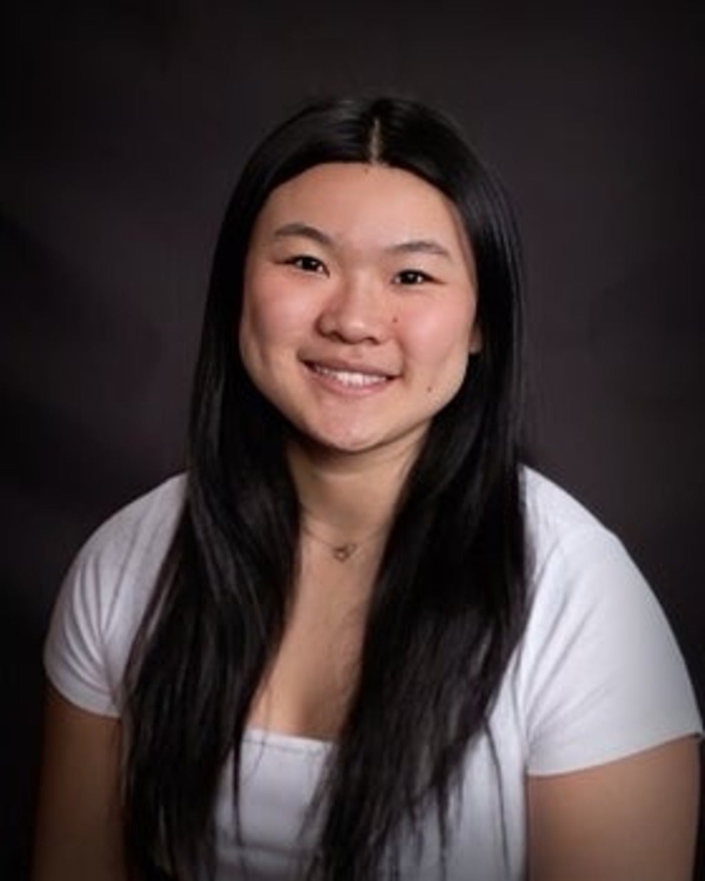 Asian girl in a white shirt in a black background