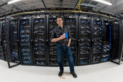 Craig Kaplan holds an einstein tile in front the Graham supercomputer
