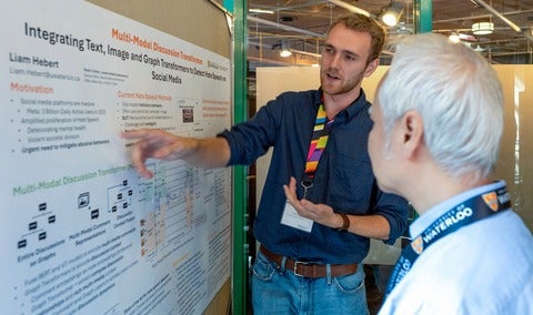 Liam Hebert discussing his research with Prof Justin Wan at the 2023 Cheriton Research Symposium