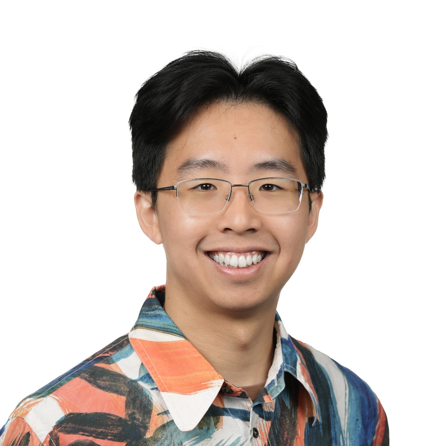 Bingjian Huang donning a orange, white and blue patterned dress shirt