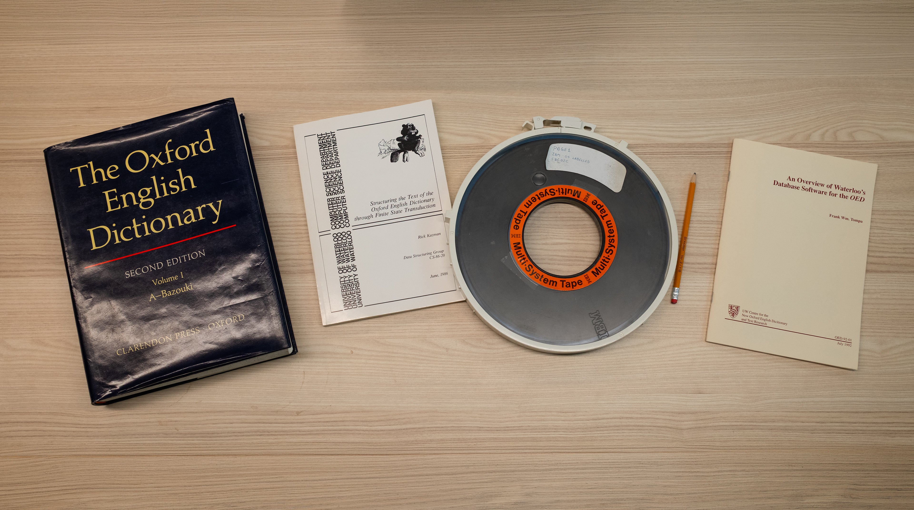 photos of an Oxford English Dictionary, two reports and magnetic computer tape