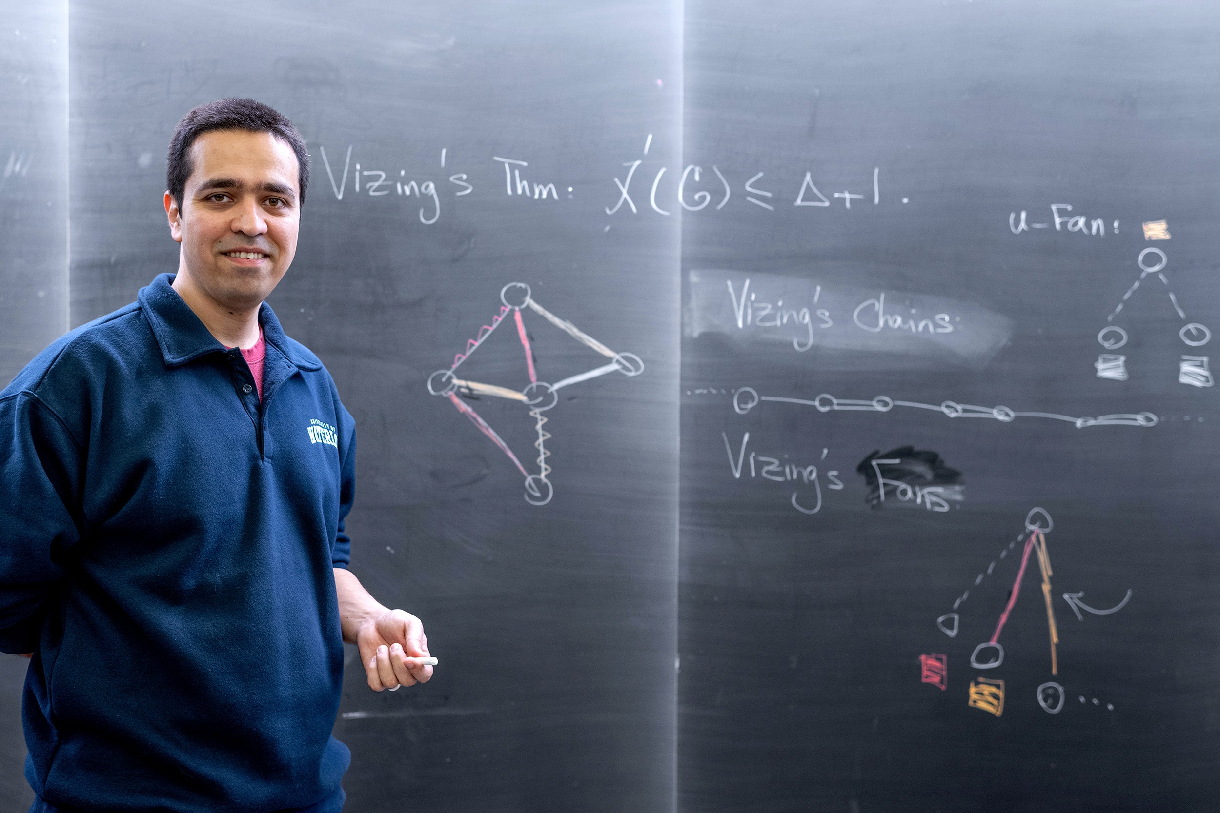 Sepehr Assadi in front of blackboard with Vizing's Theorem