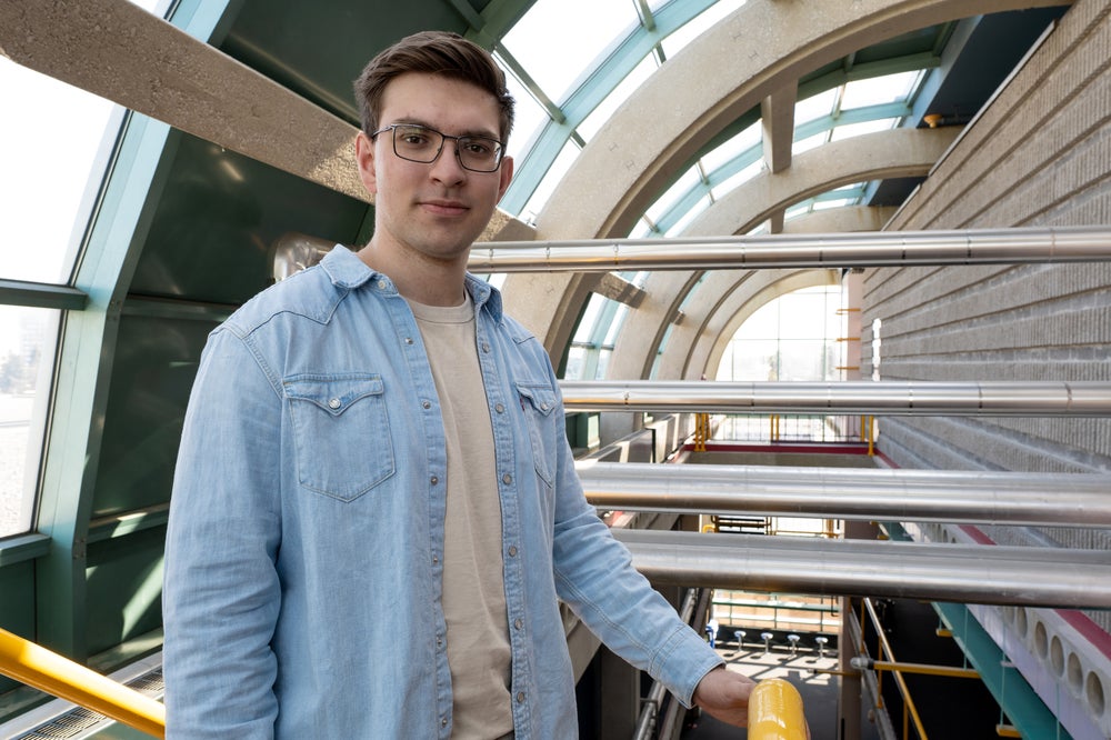 Photo of a brunet wearing a light brown shirt and a light-blue denim jacket